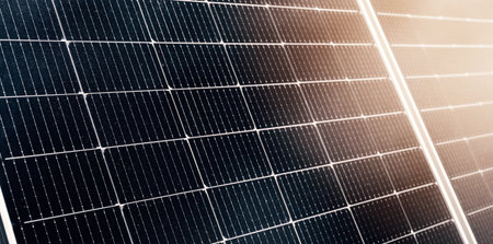 cells of modern black solar panel at sunset close-up. Green renewable energy
