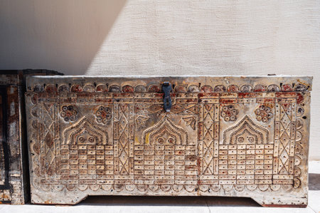 antique traditional antique Uzbek handmade wooden chest with a pattern on metal lining on the streetの写真素材