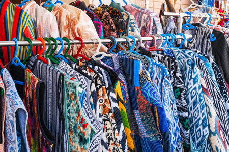 traditional Arab Uzbek dresses and female clothes made of silk and cotton with a colorful pattern at...