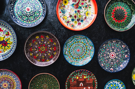 traditional oriental Uzbek ceramic plates hand-painted on black backgroundの写真素材