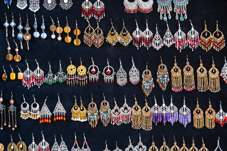 oriental Uzbek earrings in Indian Asian ethnic style on black background in bazaar in Uzbekistanの写真素材