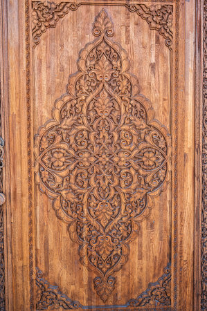 tajik kandakori patterns arabesque ornament on an ancient wooden carved door in Tajikistan close upの写真素材