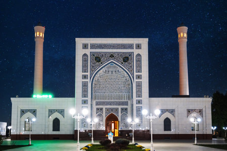 white Masjid Minor Mosque in Tashkent in Uzbekistan on background of night blue starry sky with starsの写真素材