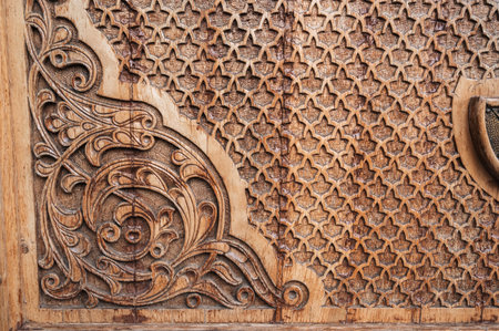 oriental asian pattern Uzbek traditional ornament on wooden carved door in Tashkent in Uzbekistan close upの写真素材