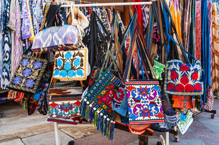 fabric bags with traditional bright colorful Asian pattern at the oriental bazaar in Uzbekistanの写真素材