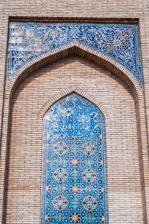 ancient ceramic tile with traditional Uzbek ornament Islamic pattern on wall of old Muslim mosque Hazrati Imam in Uzbekistan in Tashkentの写真素材
