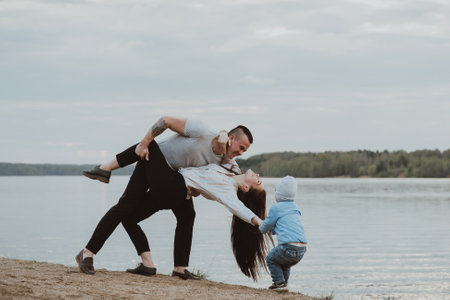 Young white family with their son on the beach on the sandの写真素材