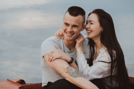 Young Caucasian happy couple hug and smile on the beachの写真素材