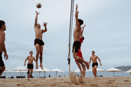 Young Asian Vietnamese play beach volleyball on sandy beach by the sea on a cloudy summer day. Nha Trang, Vietnam - July 21, 2024のeditorial素材