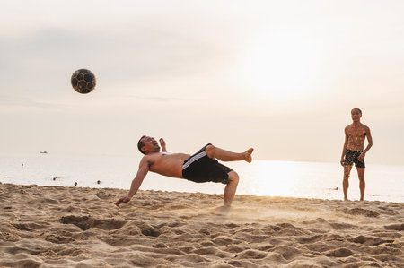 Vietnamese men play beach football on beach by the sea in summer in Nha Trang. Nha Trang, Vietnam - July 31, 2024のeditorial素材