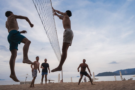 Teams with multinational players play beach volleyball by sea in Nha Trang in Asia. Nha Trang, Vietnam - August 4, 2024のeditorial素材