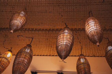 bright pendant lights with a traditional woven covering of bamboo or rattan.の写真素材