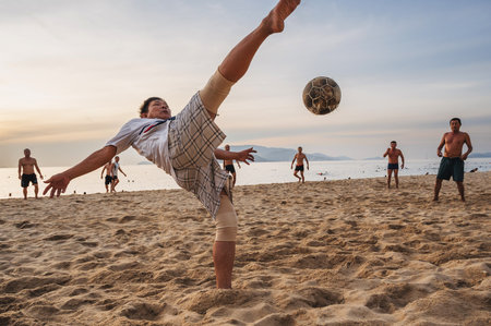 Adult Asian men play beach football on beach by the sea in summer. Nha Trang, Vietnam - July 31, 2024のeditorial素材