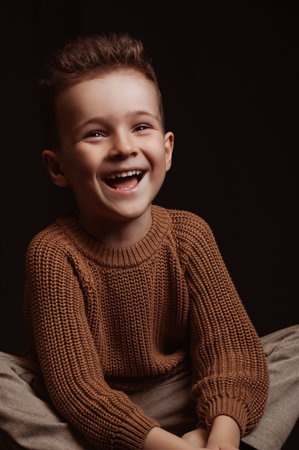happy smiling stylish white caucasian child boy preschooler a chair