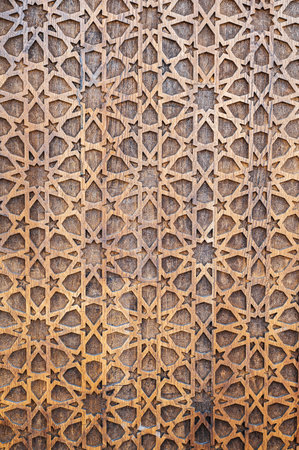 arabic Uzbek Islamic patterns ornament with stars on modern wooden carved door in Uzbekistan