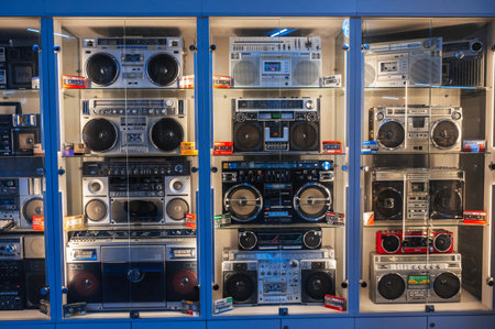 classic Japanese cassette recorders, portable boomboxes and film tape audio cassettes on shop shelf. Tashkent, Uzbekistan - April 16, 2024のeditorial素材