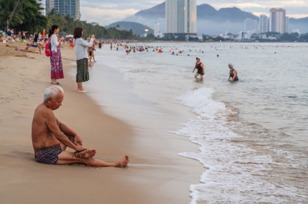 Vietnamese people on beach by the sea in Nha Trang in the morning in Vietnam. Nha Trang, Vietnam - July 18, 2024のeditorial素材