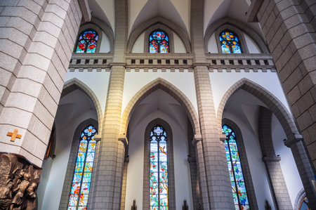 Sacred Heart of Jesus Cathedral. Interior of ancient Christian Catholic church with stained glass windows. Tashkent, Uzbekistan - April 18, 2024のeditorial素材