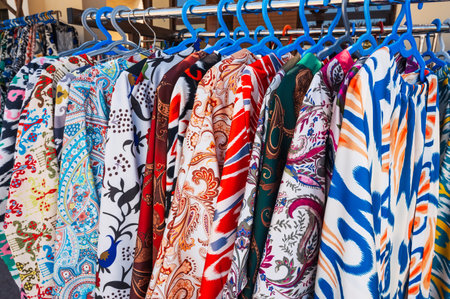 Traditional Indian dresses with a bright colored pattern at oriental bazaar close-upの写真素材