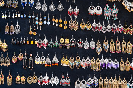 oriental Uzbek earrings in arabic ethnic style on black background in Uzbekistanの写真素材