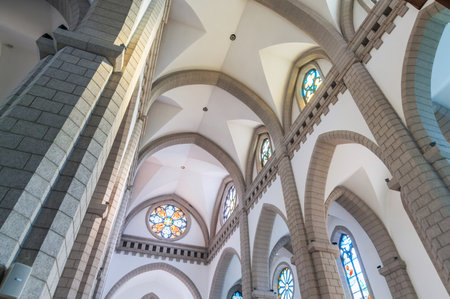 interior inside an ancient Christian Catholic church with stained glass windows. Sacred Heart of Jesus Cathedral. Tashkent, Uzbekistan - April 18, 2024のeditorial素材
