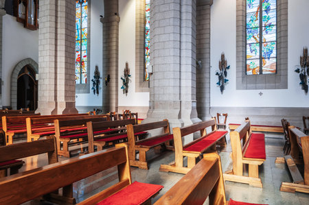 pews inside the interior of Catholic church. Cathedral of the Sacred Heart of Jesus. Tashkent, Uzbekistan - April 18, 2024のeditorial素材