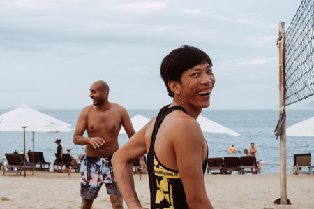 Happy beach volleyball players laugh on beach by the sea in summer. Nha Trang, Vietnam - July 21, 2024のeditorial素材