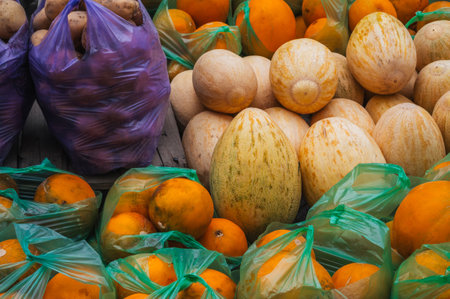 Vegetables and fruits on the counter. In boxes: potatoes, melons.の写真素材