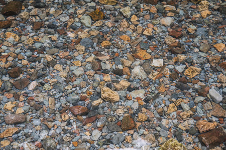 texture of stones at bottom of the river with clear clear waterの写真素材
