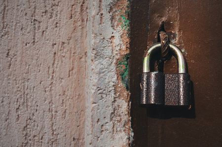 a lock hanging on an old doorの写真素材