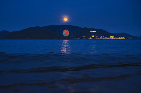 View of the island in sea with Vinpearl Amusement Park in Nha Trang in Vietnam at night in summerの写真素材