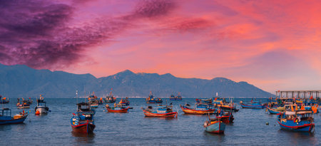 Vietnamese traditional fishing boats at sea in Vietnam at sunsetの写真素材
