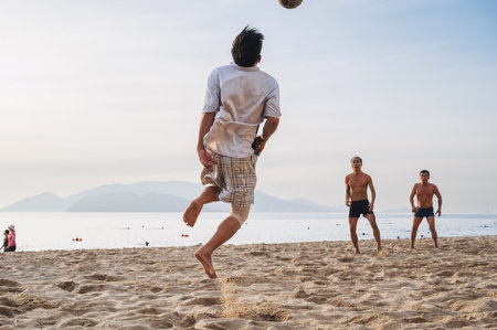 Vietnamese men play beach football on beach by the sea in summer in Nha Trang. Nha Trang, Vietnam - July 31, 2024のeditorial素材