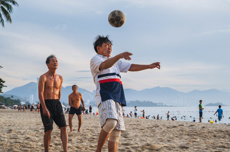 Asian men play beach soccer on beach by the sea on a summer morning. Nha Trang, Vietnam - July 31, 2024のeditorial素材