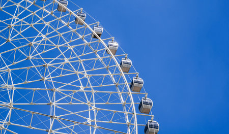 white big ferris wheel on background clear blue sky in summer close-up