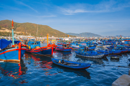 Traditional Vietnamese fishing boats, ships and vessels at the seaport on sea in Nha Trang. Nha Trang, Vietnam - September 8, 2024のeditorial素材