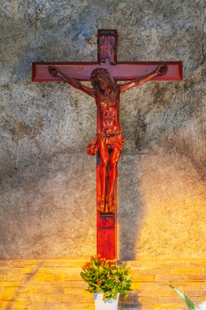 Wooden cross crucifixion with Jesus Christ God in Catholic churchの写真素材