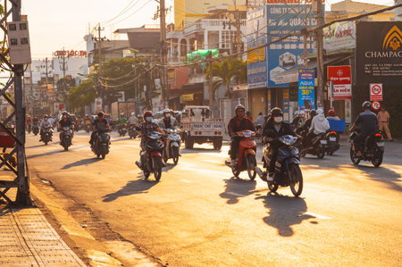 Motorbike traffic on road in a city in Asia in the summer morning at dawn. Nha Trang, Vietnam - August 22, 2024のeditorial素材