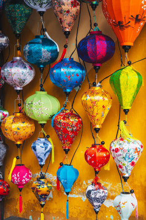 Colorful silk Chinese lanterns decorate the wall of a house in old town in Hoi An in Asiaの写真素材
