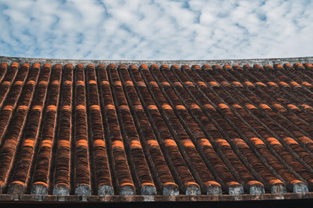 Ancient traditional orange tiles on roof of Asian old temple in Asia