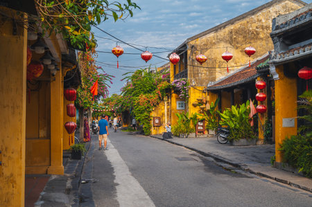 Street in old town in Hoi An city with traditional ancient yellow houses and buildings in summer. Hoi An, Vietnam - September 12, 2024のeditorial素材