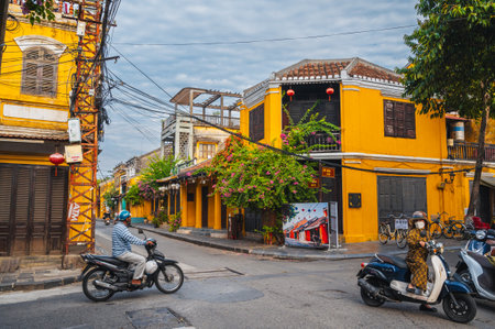 Ancient Asian streets in old town of Hoi An city with historic yellow houses. Hoi An, Vietnam -...