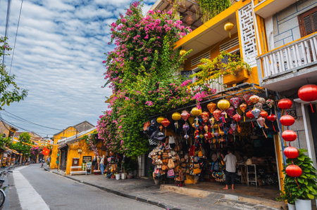 Street in old town in Hoi An city with traditional ancient yellow houses and buildings in summer. Hoi An, Vietnam - September 12, 2024のeditorial素材