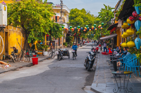 Beautiful ancient asian streets in old town of Hoi An city with historic houses and green trees. Hoi An, Vietnam - September 12, 2024のeditorial素材