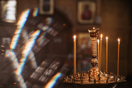 Burning wax candles in a Christian churchの写真素材