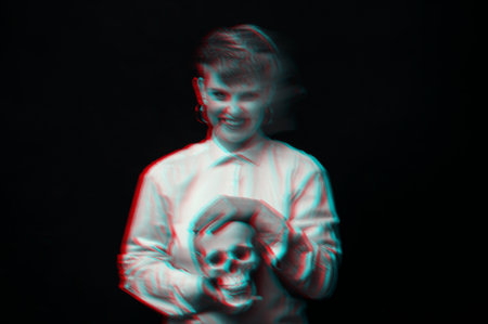 psychopath with schizophrenia and mental disorders. Portrait of girl with skull in handsの写真素材