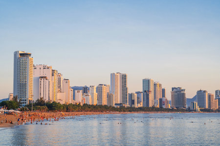 View of sandy beach by the sea and the skyscrapers hotels in the resort town on the coast in Asia in summer. Nha Trang, Vietnam - August 13, 2024のeditorial素材