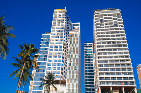 Tall modern skyscrapers of hotels against blue sky in summer in Vietnam in a resort town. Nha Trang, Vietnam - August 13, 2024のeditorial素材