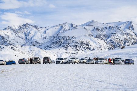 Parked cars in a parking lot in nature in mountains in winter in steppe of Kazakhstan. Shymkent, Kazakhstan - January 27, 2024のeditorial素材