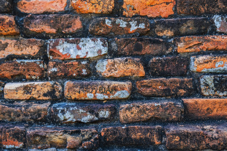 Ancient old orange brick brick wall close upの写真素材